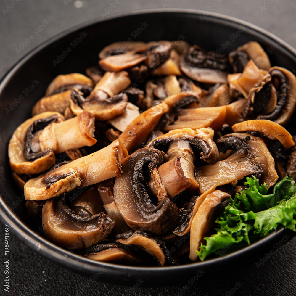 Fototapeta premium Champignon mushrooms ready to eat tasty snack fresh gourmet food background on the table rustic food top view copy space keto and paleo diet vegetarian and vegan food marketing concept photo