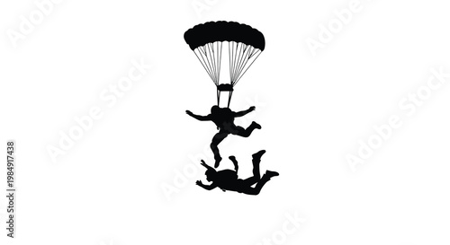 Silhouetted skydivers in freefall with an open parachute above