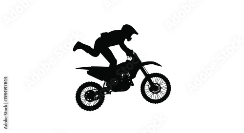 Silhouette of a motorcyclist performing a jump with their dirt bike
