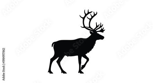 Silhouette of a majestic stag with large antlers standing in profile