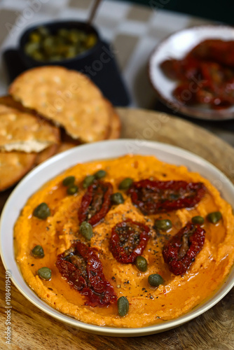 Hummus with sun-dried tomatoes and capers