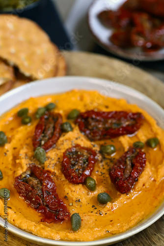 Hummus with sun-dried tomatoes and capers