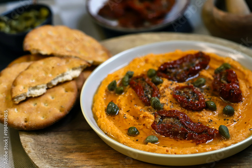 Hummus with sun-dried tomatoes and capers