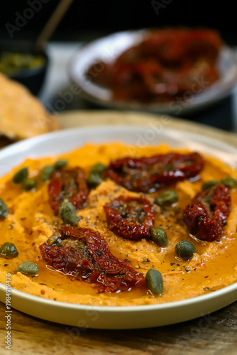 Hummus with sun-dried tomatoes and capers