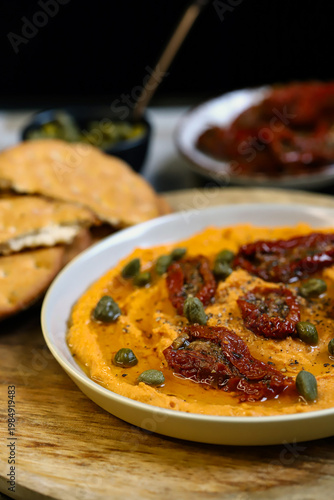 Hummus with sun-dried tomatoes and capers