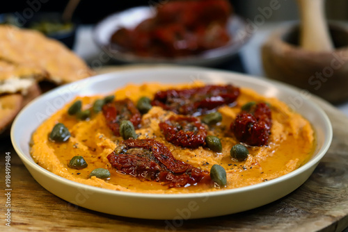 Hummus with sun-dried tomatoes and capers