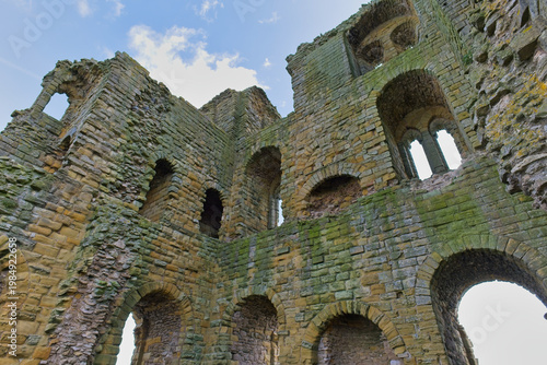 Close-up of ancient castle ruins, revealing weathered stone walls with arched windows  in Scarborough Castle - Yorkshire - Great Britain