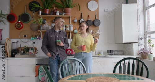 Roomies socialising over coffee in their kitchen
