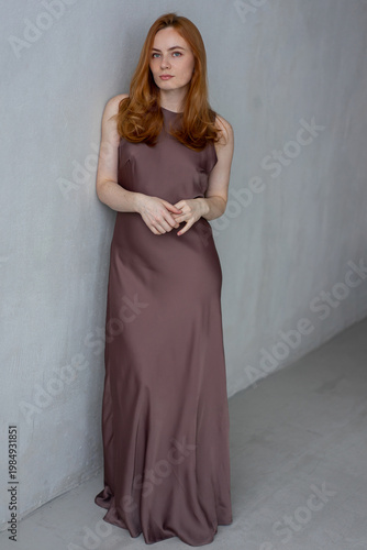 Portrait of young redhead woman with freckles in studio. Sensual expressive happy woman