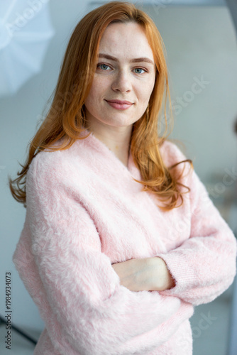 Portrait of young redhead woman with freckles in studio. Sensual expressive happy woman