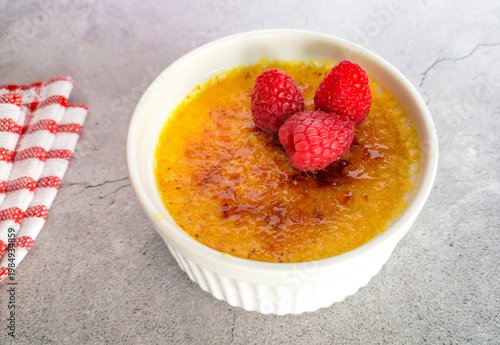 Delicious creme brulee with fresh raspberries