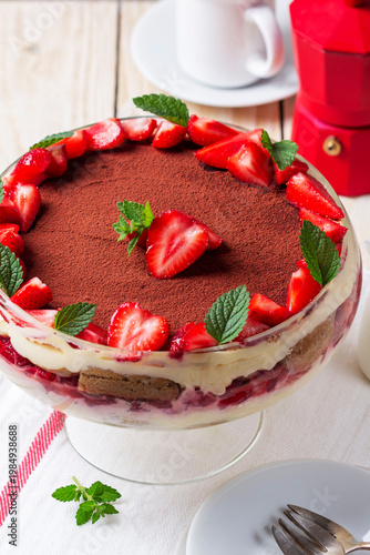 Strawberry Tiramisu Trifle Dessert with Cream Layers and Mint in Glass Bowl