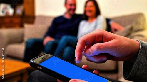 A teenager using a smartphone under parental supervision (blurred effect), social media, rules, games,education, parenting ,