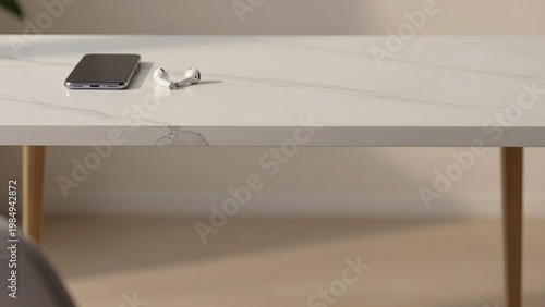 Minimalist Smartphone and Wireless Earbuds on White Marble Desk with Large Copy Space Background