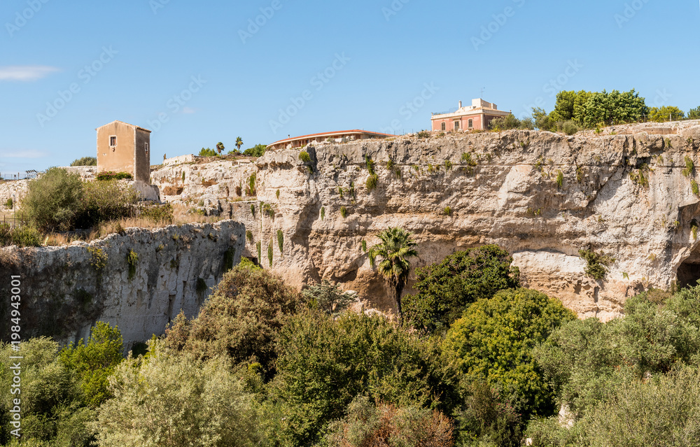 Fototapeta premium The Latomia del Paradiso inside the Neapolis Archaeological Park in Syracuse, Sicily, Italy. Historic archaeological site connected to Greek and Roman history.