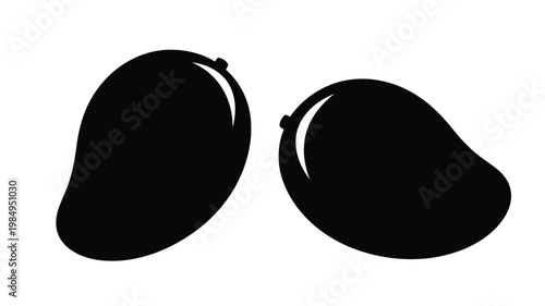 Two ripe mangoes presented in a striking black silhouette