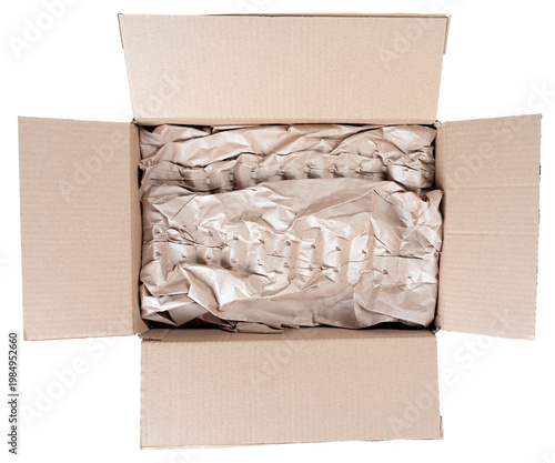 An open gray cardboard box with a bottom lined with crumpled paper. Isolated background.
