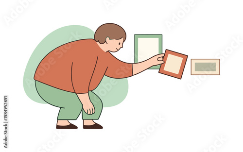 Soft person leans forward arranging photo frames, turning one gently as the display becomes harmonious  person arranging photo