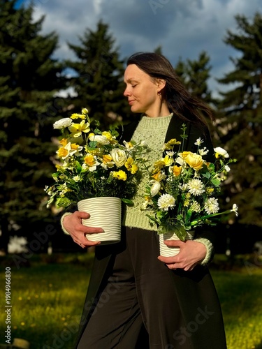 Woman Holding Spring Floral Arrangement in White Pot