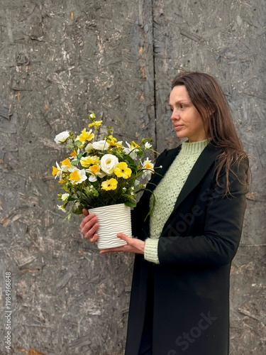 Woman Holding Spring Floral Arrangement in White Pot