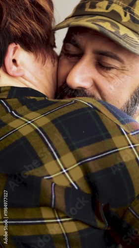 Happy military man hugging his wife at home - Welcome home and family love concept. Vertical video