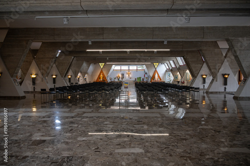 Modern church interior with symmetrical architecture and empty seating
