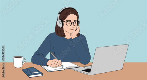 A young woman wearing headphones and glasses is studying at a laptop with a notebook and pen, a coffee mug nearby.