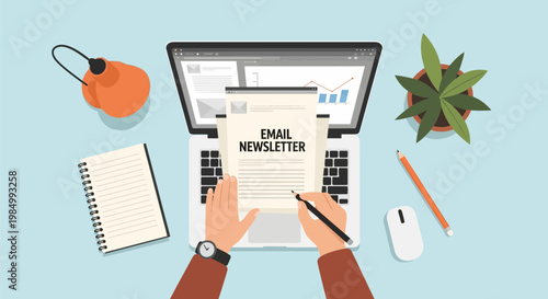 Hands writing an email newsletter on a laptop with office supplies and a plant on a desk.