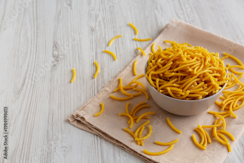 Organic Dry Raw Macaroni Pasta in a Bowl, side view.