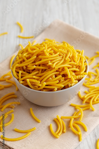 Organic Dry Raw Macaroni Pasta in a Bowl, side view.