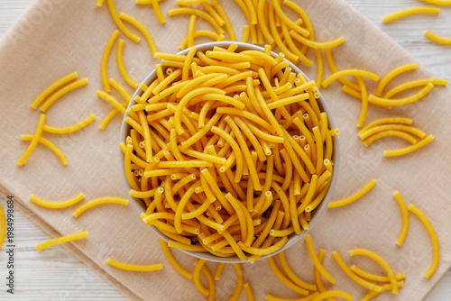 Organic Dry Raw Macaroni Pasta in a Bowl, top view.