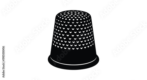 A black thimble with numerous small holes presented as a striking silhouette