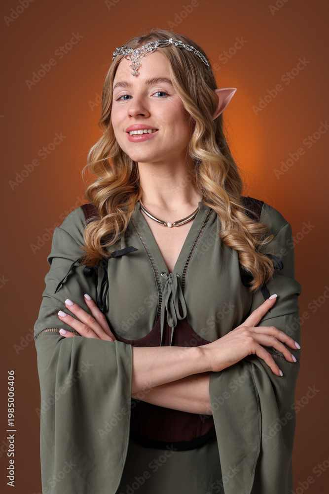 Fototapeta premium Portrait of beautiful elf girl on brown gradient background