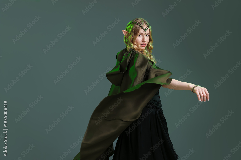 Fototapeta premium Beautiful girl dressed as elf on grey background, space for text