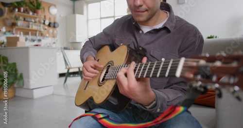 Young Adult Male Playing Guitar, Learning Music at Home