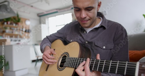 Young Adult Male Playing Guitar, Learning Music at Home