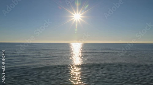 Brilliant Sun Over a Calm Sea Creates Gentle Ripples and Vivid Reflections Across Endless Waters