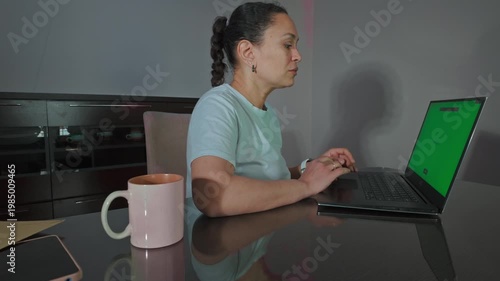 Focused Woman Working From Home on Laptop With Green Screen