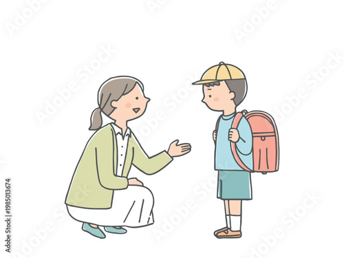 不安そうな男の子に話しかけるカウンセラーの女性