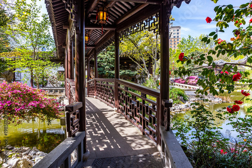 Beautiful view of the architecture and blooming bushes in the Lan Su Chinese Garden in Portland, Oregon