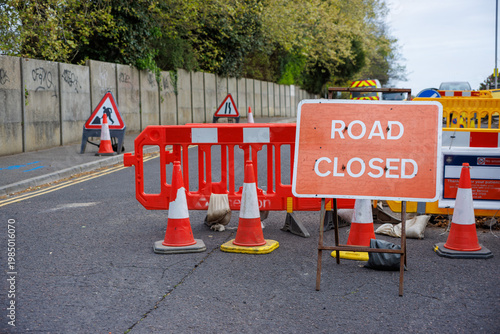 Road Closed Sign with Traffic Cones and Barriers on Urban Street