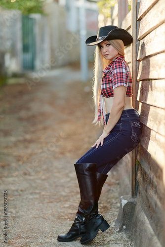 Woman sitting by wall outdoors
