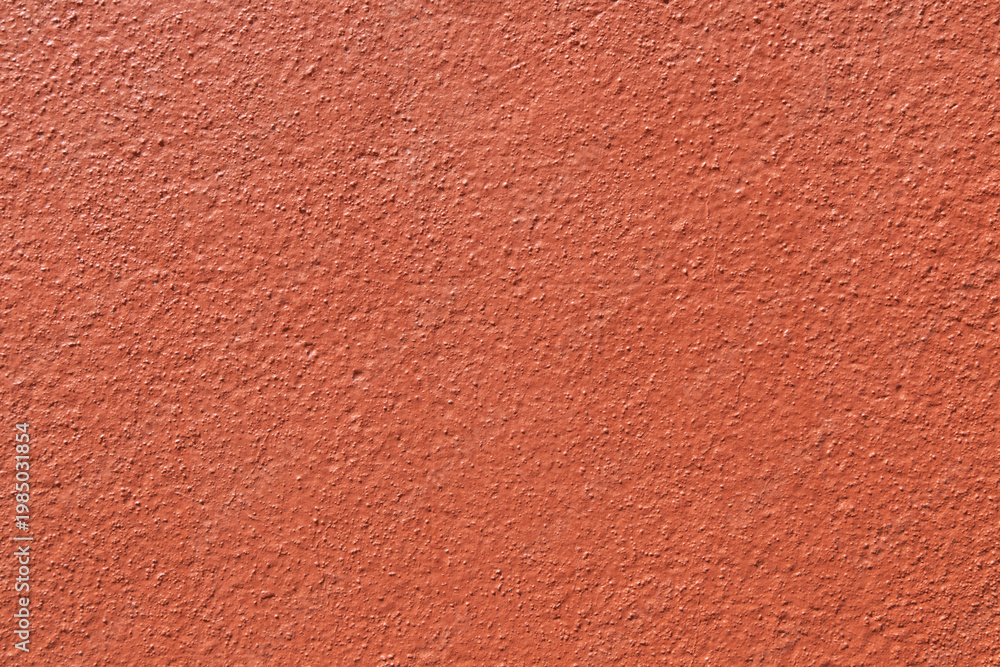 Fototapeta premium Orange stucco wall texture background. Close-up of bumpy painted terracotta plaster surface