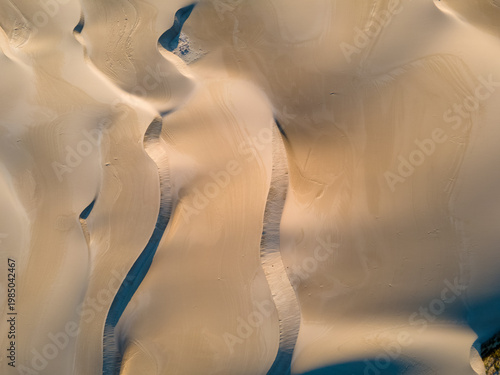 Bild auf Leinwand Aerial view of patterned sand dunes with tire tracks