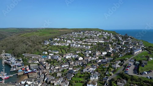 Polruan, Cornwall, England: DRONE VIEWS: A reveal shot of Polruan village as the drone rises over the River Fowey. Polruan is a river ferry crossing point and a popular UK holiday destination.