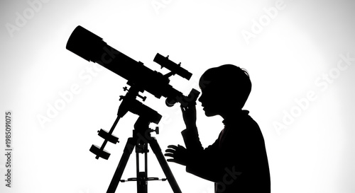 A silhouette of a boy looking through a telescope on a tripod stand