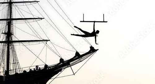 A silhouette of a person performing acrobatics on a ship with ropes and a mast