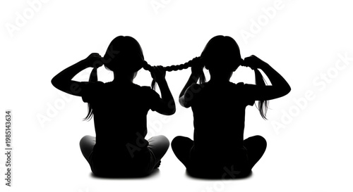 Two girls sitting in silhouette, braiding each other's hair in a symbol of friendship and unity.