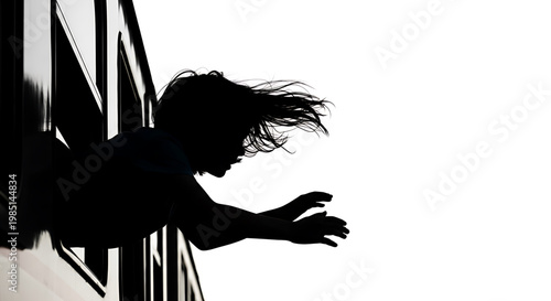 A silhouette of a woman leaning out of a window with her hair blowing in the wind