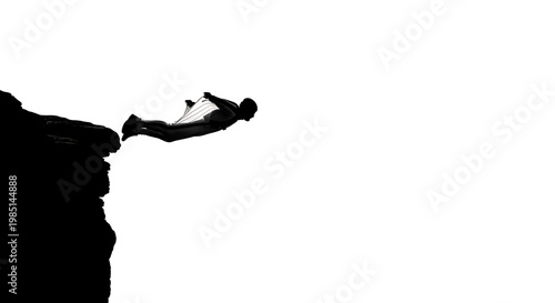 A silhouette of a man jumping off a cliff into the air with a sense of freedom and adventure.